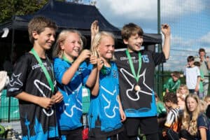 Young players celebrating with their medals